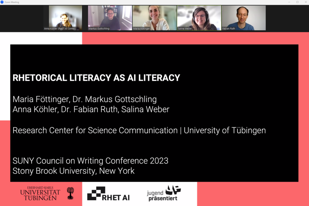 In the picture you can see a shared Zoom screen with a presentation slide and five people on top in their respective Zoom windows.

The presentation slide reads "Rhetorical literacy as AI literacy
Maria Föttinger, Dr. Markus Gottschling, Anna Köhler, Dr. Fabian Ruth, Salina Weber
Research Center for Science Communication, University of Tübingen

SUNY Council on Writing Conference 2023
Stony Brook University, New York"

On the bottom of the slide you can see the logos of the university of Tübingen, the RHET AI Center and Jugend Präsentiert (Youth Presents).